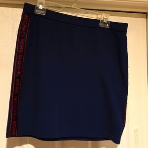 Michael Kors blue skirt with red MK logo down the side.